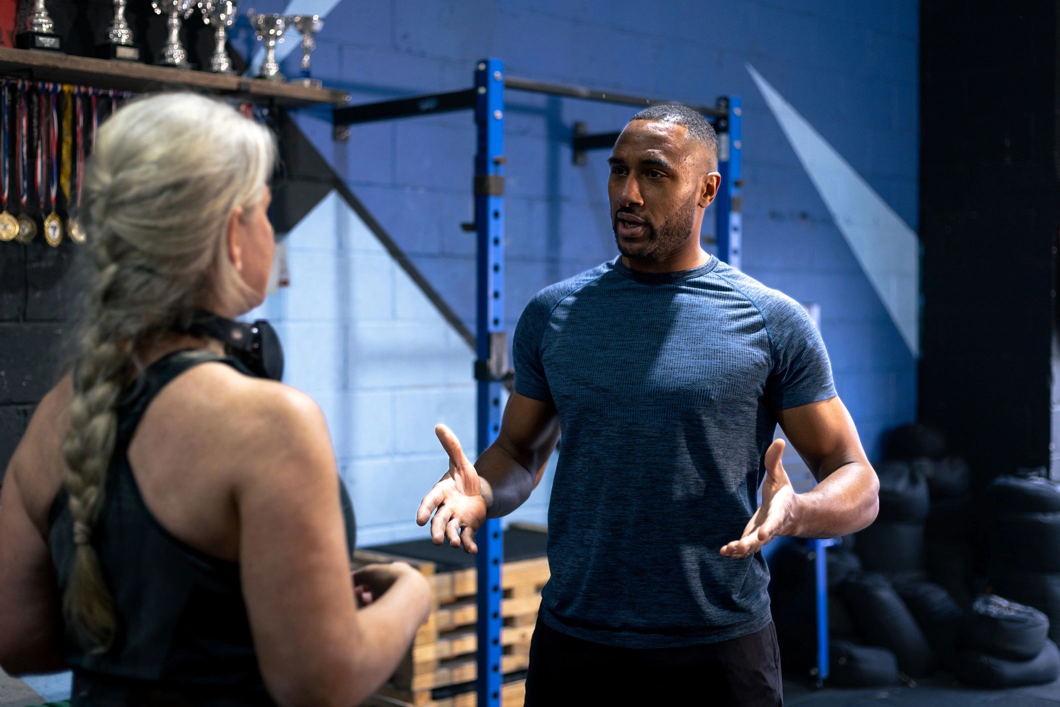 Trainer encouraging a client during a gym session