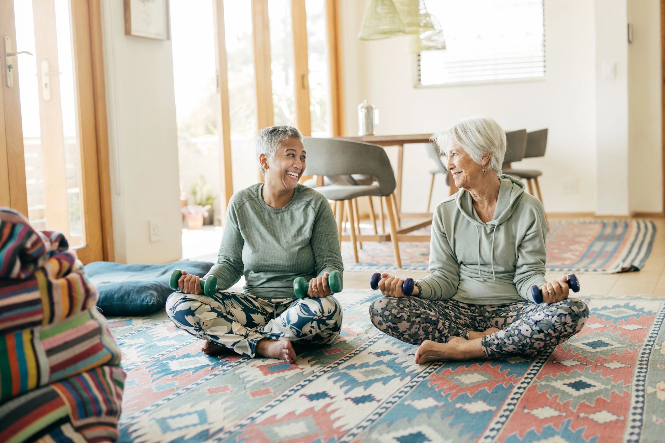 Woman exercising at home with light weights